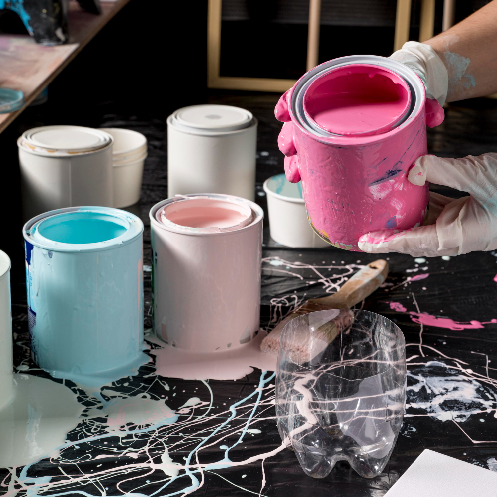 artist using pink paint from can